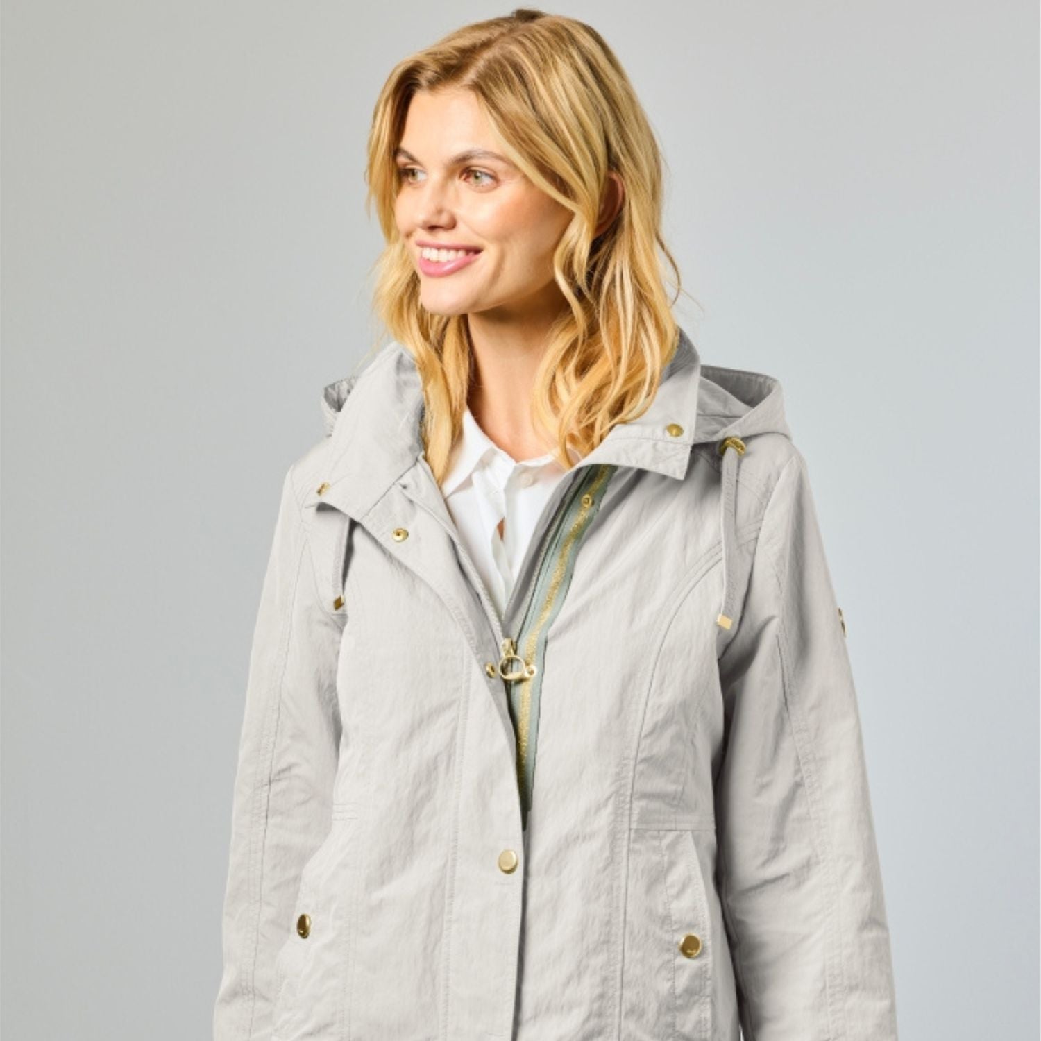 Women's summer jacket in silver with gold snap buttons and striped trim details along the zip.
